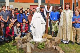 Students and staff attend the blessing of statues of Mary and Joseph, which were relocated to St. Joseph High School in Edmonton after their last home, a monastery, was closed.