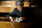  A woman holding a rosary prays Oct. 1 at St. Joseph Catholic Church in Beijing. 