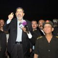 Egyptian President Mohammed Morsi is flanked by high-ranking military personnel as he address soldiers at a checkpoint in El-Arish Aug. 10.