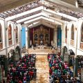 People gather for Mass Nov. 24 in the damaged Basilica of the Holy Child in Tacloban, Philippines.