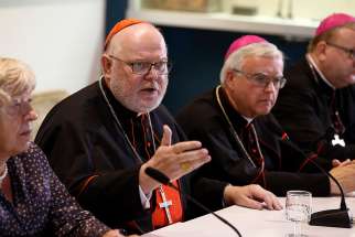 Cardinal Reinhard Marx of Munich-Freising, president of the German bishops&#039; conference, and other German bishops and a lay synod observer, hold a press conference at the Vatican after the opening session of the Synod of Bishops on the family at the Vatican in 2015.