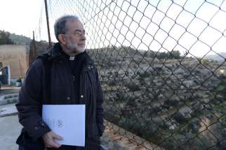 Bishop Lionel Gendron of Saint-Jean-Longueuil, Quebec, looks through a fence at the Cremisan Valley from the Salesian Sisters&#039; convent in Beit Jalla, West Bank, Jan. 13. Bishop Gendron is part of the Holy Land Coordination visit for bishops from Europe and North America.