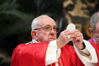 Pope Francis elevates the Eucharist during a Mass for deceased cardinals and bishops in St. Peter&#039;s Basilica at the Vatican Nov. 3.