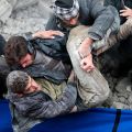 People carry a survivor from the rubble at a damaged site after what activists said was heavy shelling by forces loyal to Syrian President Bashar Assad in Damascus Dec. 26. Many Syrian refugees found Christmas a difficult time with the ongoing violence i n their homeland.