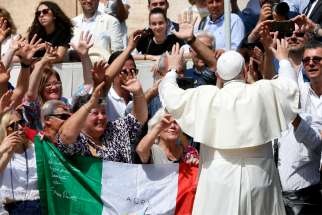Pope Francis uses sign language in response to a group of people using sign language during his general audience in St. Peter&#039;s Square at the Vatican June 12, 2019.
