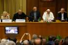Pope Francis addresses a workshop on climate change and human trafficking attended by mayors from around the world in the synod hall at the Vatican July 21. Local government leaders were invited to the Vatican by the pontifical academies of sciences and social sciences to sign a declaration recognizing that climate change and extreme poverty are influenced by human activity. Also seen are, from left, Argentine model Valeria Mazza, serving as master of ceremonies; Bishop Marcelo Sanchez Sorondo, chancell or of the Pontifical Academy of Sciences; Cardinal Francesco Montenegro of Agrigento, Italy; and Cardinal Claudio Hummes, former prefect of the Congregation for the Clergy.