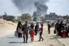 Smoke rises following an Israeli airstrike as displaced Palestinians make their way to flee areas in the eastern part of Khan Younis following an Israeli evacuation order, amid the ongoing Israel-Hamas war, in Khan Younis in the southern Gaza Strip Oct. 7, 2024.