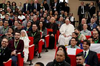  Pope Francis poses for a photo at a pre-synod gathering of youth delegates at the Pontifical International Maria Mater Ecclesiae College in Rome March 19. The meeting was in preparation for the Synod of Bishops on young people, the faith and vocational discernment this October at the Vatican. Seated next to the pope are Cardinal Lorenzo Baldisseri, secretary-general of the Synod of Bishops, and U.S. Cardinal Kevin J. Farrell, prefect of the Vatican&#039;s Dicastery for Laity, Family and Life.