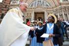 Cardinal Vincent Nichols of Westminster, England, greets Catholic school children outside Westminster Cathedral in London.