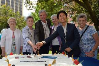 From left, Sr. Ann Delaney, Sr. Thérèse Meunier, St. Michael’s Hospital president Dr. Bob Howard, Sr. Mary Anne McCarthy, city councillor Kristyn Wong-Tam and Sr. Georgette Gregory cut the cake at the hospital’s 125th birthday celebration.   Although the Sisters of St. Joseph are no longer in control of St. Michael’s Hospital, their legacy lives on at the downtown Toronto hospital.