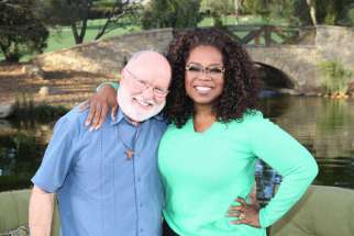 Franciscan Father Richard Rohr poses for a photo with Oprah Winfrey on the set of &quot;Super Soul Sunday&quot; during the taping of the show Nov. 12, 2014. The show runs on OWN, the Oprah Winfrey Network, Sunday, Feb. 8, 11 a.m. ET. Father Rohr will be the first Catholic priest to appear on &quot;Super Soul Sunday&quot; since the series debuted in fall 2011, 101 episodes ago. 
