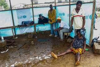 Liberians wait outside the John F. Kennedy Ebola treatment center in Monrovia, Liberia, Sept. 18. Pope Francis called for prayers and concrete help for the thousands of people affected by the deadly Ebola virus.