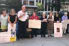 David Lorenz, holding the microphone, addresses a crowd gathered outside the Cathedral of St. Matthew the Apostle in Washington Aug. 26. Joined by Catholics who showed up to support sex abuse victims, Lorenz, a survivor of clergy abuse, called on Cardinal Donald W. Wuerl to resign.