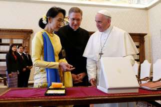 Pope Francis exchanges gifts with Aung San Suu Kyi, leader of Myanmar, during a private audience at the Vatican May 4.