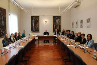 Cardinal Gianfranco Ravasi, center, and Bishop Paul Tighe pose at a 2019 meeting of the Women&#039;s Consultation Group at the Vatican. The 20 members of the group, Catholics, other Christians and members of other faiths, met online Oct. 7 for a webinar reflecting together on Pope Francis&#039; 2013 exhortation, &quot;The Joy of the Gospel.&quot; 