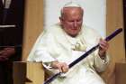 St. John Paul II swings a St. Louis Blues’ hockey stick given to him by young people during his visit to the Kiel Center in St. Louis for a rally on Jan. 26, 1999.