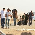 Syrian refugees fleeing the violence in their country make their way to a refugee camp in the Jordanian city of Mafraq.