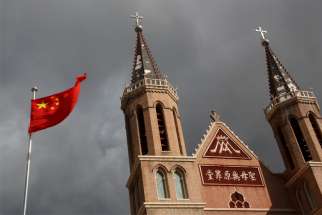 The Chinese national flag flies in front of a Catholic church in the village of Huangtugang, Hebei province, China, Sept. 30, 2018.
