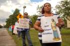 Edith Smith holds a sign while praying with a finger rosary during a Life Chain event in front of Immaculate Conception Church in Goose Creek, S.C., Oct. 7, 2018. The number of abortions occurring annually in South Carolina continues to fall, a trend welcomed by advocates who credit pro-life legislation and increased public awareness for the decline.