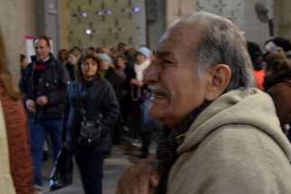 Catholic pilgrims are regularly overcome with emotion at the Shrine of Our Lady of the Rosary of San Nicolas, as this man was while visiting it on July 25, 2016, in San Nicolas de Arroyos, Argentina.