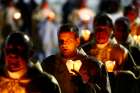 Catholic clergymen carry candles during the annual feast of the Icon of the Mother of God procession July 5, 2019, in Budslau, Belarus.