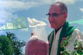 Then-Archbishop Oscar Romero receives a sack of beans from parishioners following Mass outside of a church in San Antonio Los Ranchos in Chalatenango, El Salvador, in 1979. Dominican Father Gustavo Gutierrez, considered by many as the father of liberation theology, said he supports an effort to declare now-St. Oscar Romero a doctor of the Catholic Church.