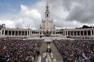 A statue of Our Lady of Fatima is carried through a crowd in 2016 at the Marian shrine of Fatima in central Portugal.