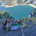 Delegates hold the Portuguese version of the campaign banner, on which 80,000 Canadians signed their support of small-scale farmers to help cool the earth, on Sugarloaf mountain overlooking Copacabana Beach.