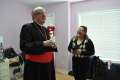 Toronto’s Cardinal Thomas Collins shares a laugh with Eman Jajoo Shakar as she gives him a tour of her new house. The Shakar family, the first Iraqi refugees welcomed by the Archdiocese of Toronto in 2009, now have their own home in Brampton, Ont.