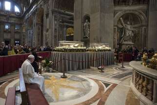 Pope Francis prays in front of the coffins containing the exhumed bodies of Sts. Padre Pio and Leopold Mandic displayed in St. Peter&#039;s Basilica at the Vatican Feb. 6. The bodies were brought to Rome at the request of Pope Francis for the Year of Mercy.