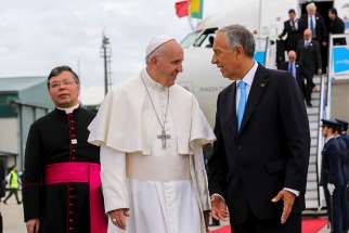 Pope Francis chats with Portuguese President Marcelo Rebelo de Sousa after the pontiff arrived May 12 at Monte Real air base in Leiria, Portugal.
