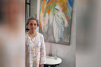 Sunita Kumar poses for a photo with her painting of Blessed Teresa March 18 at the headquarters of the Missionaries of Charity in Kolkata, India. Kumar said she once told Mother Teresa she did not paint the nun&#039;s physical features because she recognized her as a saint. 
