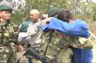 Pvt. Andry Rosales hugs a Colombian soldier after defecting from Venezuela Feb. 27, 2019. Rosales snuck out of an army base and crossed into Colombia in civilian clothes. 