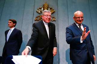 Jean-Baptise de Franssu, left, new president of the Vatican bank, outgoing President Ernst Von Freyberg, right, and Australian Cardinal George Pell, prefect of the Vatican Secretariat for the Economy, leave at the end of a news conference at the Vatican July 9. The Vatican said it will separate its bank&#039;s investment business from its church payments work to try to clean up after years of scandal, including allegations of money laundering and tax evasion.