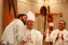 Archbishop Charles J. Chaput of Philadelphia receives a hand-carved crosier July 24 from artist Mark McAllister during the annual Tekakwitha Conference in Fargo, N.D. The staff features a likeness of St. Kateri Tekakwitha. Before his homily, Archbishop C haput announced that Pope Francis has accepted his invitation to attend the World Meeting of Families in the U.S. next year. The Philadelphia Archdiocese said later it has not received official confirmation from the Vatican.