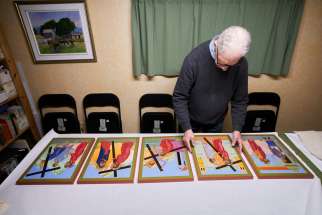 Artist Steven Knight looks at a selection of the stations of the cross icon set that he has been working to create.