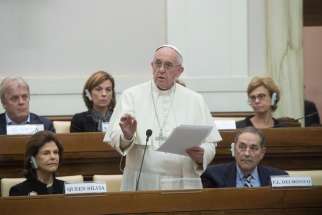 Pope Francis, seen her speaking a few days earlier at a social science workshop, says it is up to scientists to create a cultural model to solve global problems, such as climate change, Nov. 28.