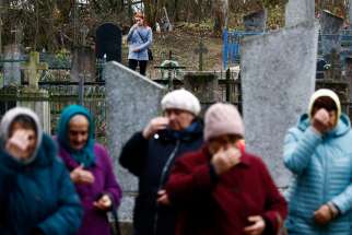 People in Starayelnya, Belarus, visit graves during All Saints Day Nov. 1, 2019. In a video message to young people participating in the World Youth Encounter in Mexico City, Pope Francis said death teaches people to &quot;relate with mystery&quot; and to trust that there is something beyond death.