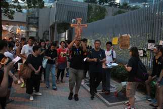 About 100 Catholic youths pray for democracy outside Hong Kong&#039;s government headquarters building Sept. 30. Two cardinals in Hong Kong urged the government to solve the present political deadlock after police used force to disperse thousands of unarmed p rotesters who struggled for full democracy in the city.