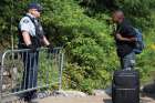 A Haitian man talks with an RCMP officer as he waits to cross the U.S.-Canada border into Quebec last summer. 