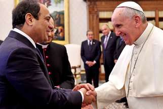 Pope Francis and Egypt&#039;s President Abdel Fattah al-Sisi shake hands during a private audience in 2014 at the Vatican. 