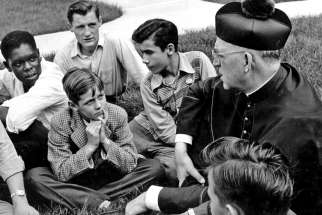 Fr. Edward Flanagan talks with a group of boys in this undated photo.