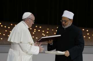 Pope Francis and Sheik Ahmad el-Tayeb, grand imam of Egypt&#039;s al-Azhar mosque and university, exchange documents during an inter-religious meeting at the Founder&#039;s Memorial in Abu Dhabi, United Arab Emirates, Feb. 4. 