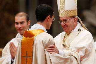 Pope Francis greets a new priest during the ordination Mass of 11 priests in St. Peter&#039;s Basilica at the Vatican April 17.