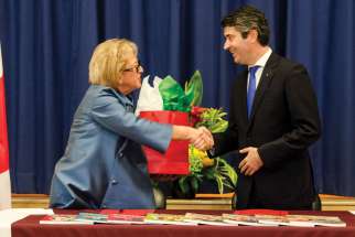 Angela Gauthier, left, and José Luis Carneiro seal the deal between Toronto’s Catholic school board and the Portuguese government with a hand shake.