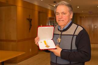 Mario Biscardi with his Cross Pro Ecclesia et Pontifice medal. 