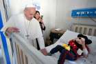 Pope Francis greets a patient during an unannounced visit to the Palidoro Bambino Gesu Hospital, in Fiumicino, outside Rome, in this Jan. 5, 2018, file photo. 