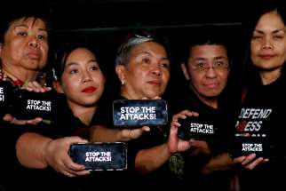 Journalists, including Rappler CEO Maria Ressa, raise their smart phones with words &quot;STOP THE ATTACKS!&quot; in a rally for press freedom in Quezon City, Philippines, Feb.15, 2019. Church leaders across Asia have expressed alarm over threats to press freedom amid reports of increasing attacks and intimidation of journalists, resulting in growing levels of self-censorship. 