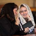 Laura Gambino smiles at her mother Kathleen Gambino before the start of a traditional Latin Mass at St. Michael the Archangel Chapel in Farmingville, N.Y. Many young people are finding their way to the traditional Mass. 