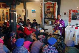 Posters of Chinese President Xi Jinping hang on the wall of the house of a Tibetan Catholic during a Mass celebrated by Father Yao Fei on Christmas Eve in Niuren village, in China&#039;s Yunnan province, in this Dec. 24, 2018, file photo.